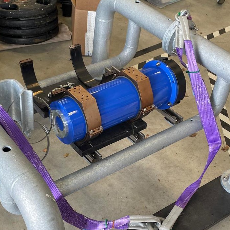 Blue subsea battery pack mounted in a galvanised steel deployment frame