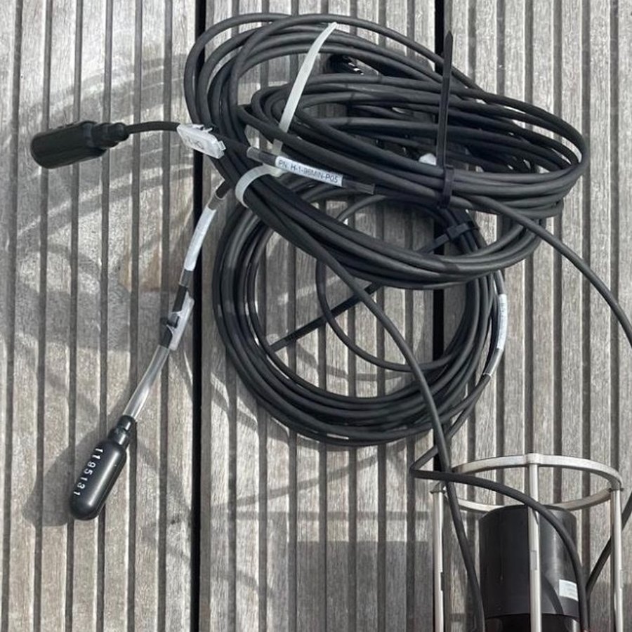Hydrophone with its coiled cable on a wooden deck